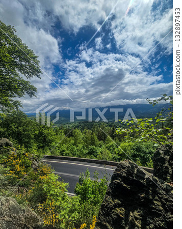 Mountain Horizons Road Through Majestic Peaks 132897453