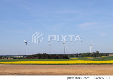 Wind Turbines on Green Field Under Clear Sky Wind Turbines on Green Field Under Clear Sky 132897997