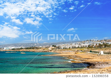 Picturesque Coastal Scenery with Turquoise Waters and White Buildings Under a Blue Sky 132898358