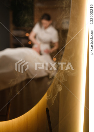 Relaxing massage therapy session in a tranquil spa with soft lighting and calming atmosphere Relaxing massage therapy session in a tranquil spa with soft lighting and calming atmosphere 132900216