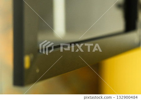 Close-up view of a modern black microwave showing its sleek design and clean lines, ideal for contemporary kitchens and culinary spaces 132900484