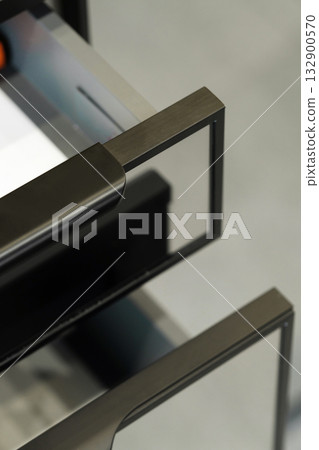 Metallic drawer handles close-up showcasing sleek design and modern craftsmanship in a contemporary interior setting Metallic drawer handles close-up showcasing sleek design and modern craftsmanship in a contemporary interior setting 132900570