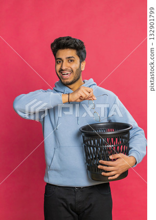 Man taking off, throwing out glasses into bin after medical vision laser treatment therapy surgery 132901799