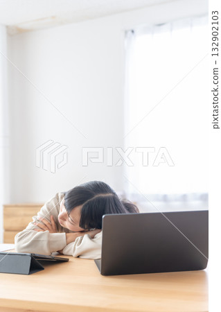 A young woman taking a break after studying 132902103