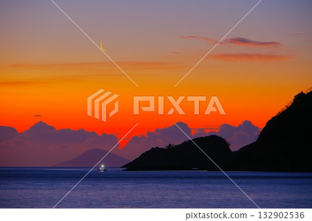 A calm seascape with a crimson morning sky and a crescent moon Ver.2 A calm seascape with a crimson morning sky and a crescent moon Ver.2 132902536