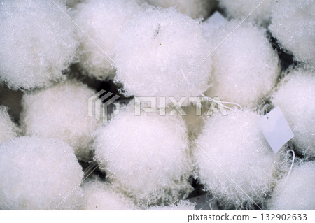 Soft and fluffy artificial snowballs arranged in a cozy, minimal winter display. Scandinavian decor, cozy holiday vibe, hygge Christmas, snow-themed simplicity, white holiday accents Soft and fluffy artificial snowballs arranged in a cozy, minimal winter display. Scandinavian decor, cozy holiday vibe, hygge Christmas, snow-themed simplicity, white holiday accents 132902633