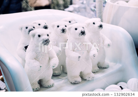 Group of glittery white polar bear plush decorations arranged in a festive retail display. Christmas decor, winter animal theme, whimsical holiday accents, arctic-inspired celebration Group of glittery white polar bear plush decorations arranged in a festive retail display. Christmas decor, winter animal theme, whimsical holiday accents, arctic-inspired celebration 132902634