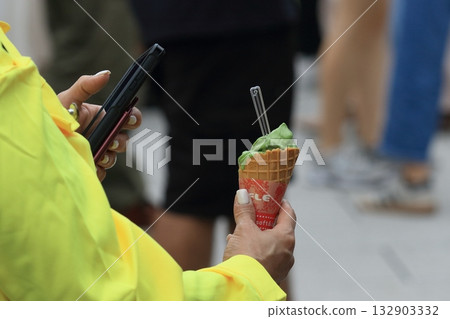 A tourist taking a photo of matcha soft serve ice cream 132903332