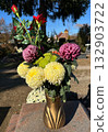 Flowers in a vase in the public cemtery 132903722
