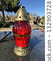 Candlelit on a tombstone in the public cemetery 132903728