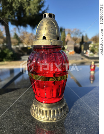Candlelit on a tombstone in the public cemetery Candlelit on a tombstone in the public cemetery 132903728