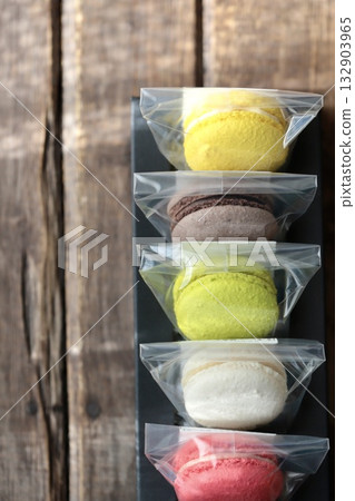 Colorful macarons individually wrapped and arranged in a box Colorful macarons individually wrapped and arranged in a box 132903965