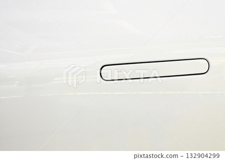 Retractable handle of modern car door on a white body. 132904299