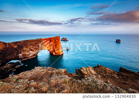 Amazing black arch of lava standing in the sea. Location cape Dyrholaey, Iceland, Europe. 132904830
