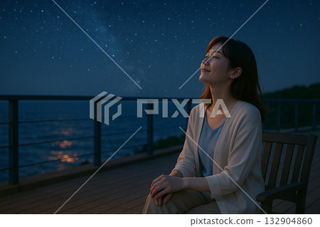 A woman relaxing on the beach at night 132904860