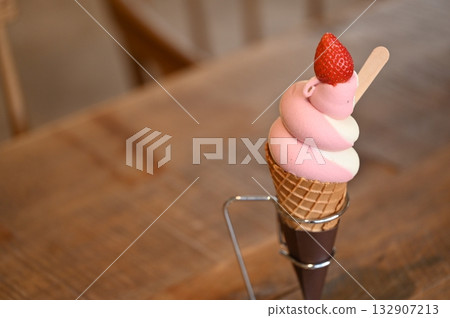 Strawberry Soft Serve Ice Cream Cone, pink and white with strawberries 132907213