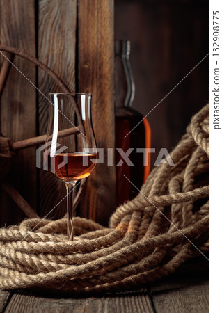 Snifter and bottle with rum, cognac, or whiskey. 132908775