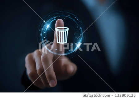 A finger touches a digital trash can icon to delete data. A finger touches a digital trash can icon to delete data. 132909123