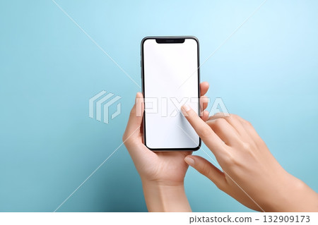 A hand holds a phone and touches the screen with a finger. 132909173