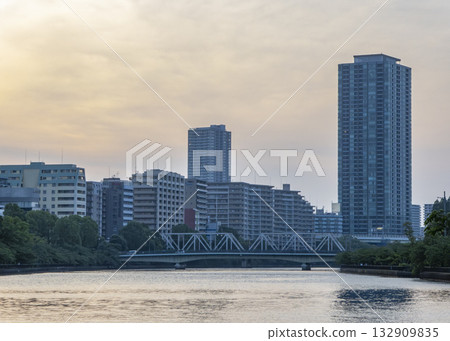 Towering apartment buildings and a bridge across the river 132909835