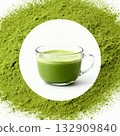 Clear glass cup filled with frothy matcha, surrounded by green matcha powder for a vibrant and health-focused presentation.  132909840