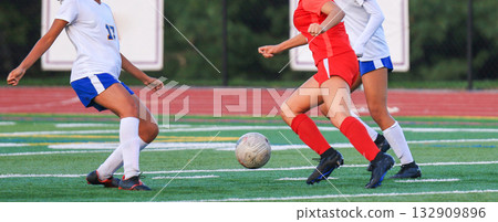Soccer Players Competing on a Green Field During a Match 132909896