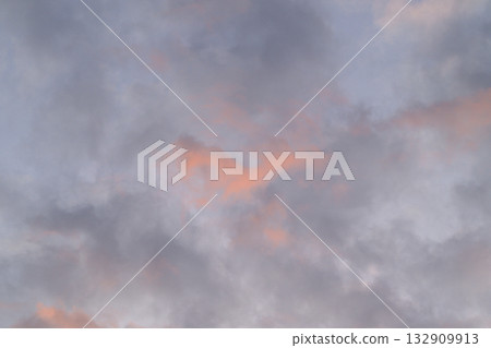 A breathtaking display of dramatic sunset clouds showcasing beautiful hints of various colors 132909913