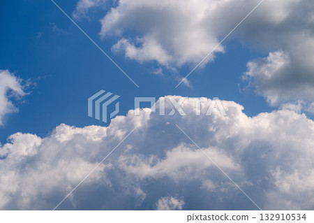 Fluffy, White, and Beautiful Clouds Floating Gracefully Under a Bright Blue Sky Above Us 132910534