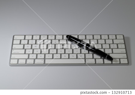 Black fountain pen on a keyboard 132910713