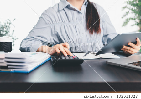 Business woman analyze calculate company financial, tax results office accounting statistics analytical research. calculating business balance prepare tax reduction. Tax deduction planning concept. 132911328