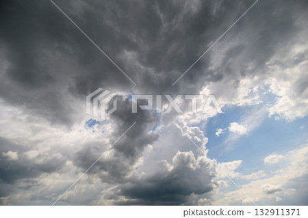 A Stunning and Dramatic Sky Filled with Beautiful Clouds and a Vibrant Blue Sky Above 132911371