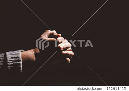 Person clasping hands in prayer, symbolizing faith, hope, spirituality, devotion, inner strength, meditation, belief, healing and the power of trust during difficult times in life. Person clasping hands in prayer, symbolizing faith, hope, spirituality, devotion, inner strength, meditation, belief, healing and the power of trust during difficult times in life. 132911415