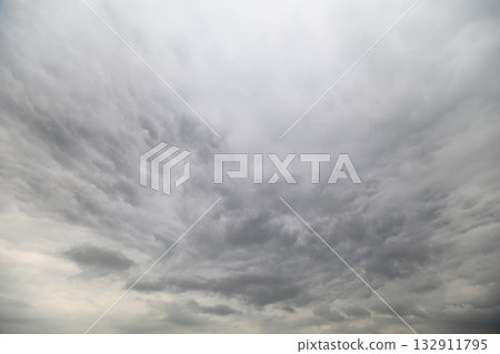 The scene depicts a dramatic, cloudy sky that creates an overcast and moody atmosphere 132911795