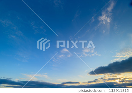 A Serene Blue Sky Filled with Gentle, Soft Cloud Patterns at Beautiful Sunset Time A Serene Blue Sky Filled with Gentle, Soft Cloud Patterns at Beautiful Sunset Time 132911815