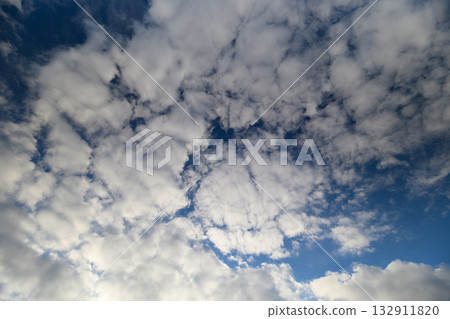 There is a beautiful and stunning cloudy sky that features a lovely blue background 132911820