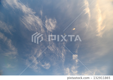A Beautiful and Expansive Sky That Features Wispy Clouds and Offers a Truly Breathtaking View Above 132911865