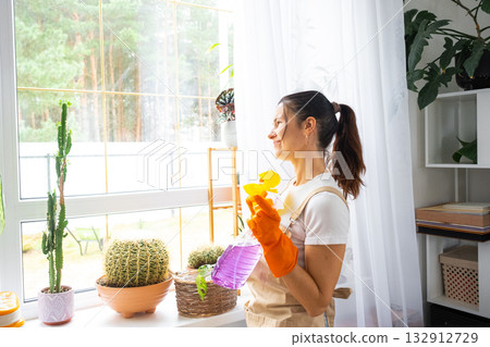 A sad tired woman does not want to wash the windows and clean the house, negative emotions, burnout. Restoring order and cleanliness, cleaning servise A sad tired woman does not want to wash the windows and clean the house, negative emotions, burnout. Restoring order and cleanliness, cleaning servise 132912729