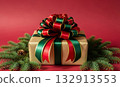 Christmas gift box wrapped in gold, featuring a large red and green bow, surrounded by fir branches and pine cones on a red background. 132913553
