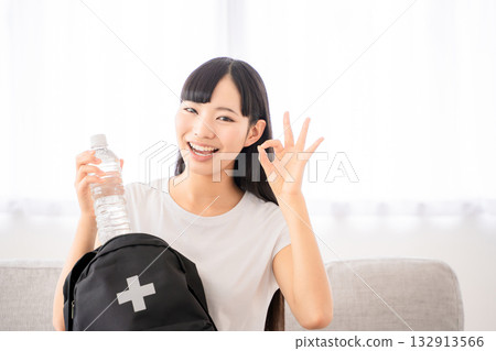 Young woman with disaster prevention backpack Young woman with disaster prevention backpack 132913566