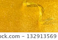 Festive Golden Glitter Background With Curled Ribbon On Sparkling Surface. Background for Festive Party Decor, Glamorous Holiday Invitations, Luxury Event Designs, And Elegant Seasonal Visuals 132913569