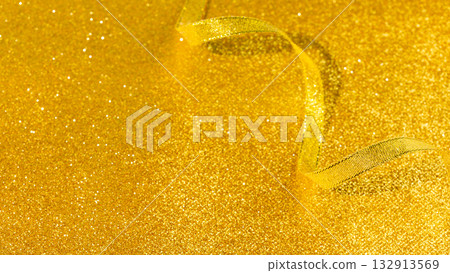 Festive Golden Glitter Background With Curled Ribbon On Sparkling Surface. Background for Festive Party Decor, Glamorous Holiday Invitations, Luxury Event Designs, And Elegant Seasonal Visuals Festive Golden Glitter Background With Curled Ribbon On Sparkling Surface. Background for Festive Party Decor, Glamorous Holiday Invitations, Luxury Event Designs, And Elegant Seasonal Visuals 132913569