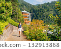 Smiling woman explores Nachi Falls and Seigantoji Temple, a beautiful Japanese cultural site 132913868