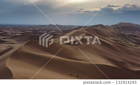 Aerial view of sand dunes in desert at sunset 132914293
