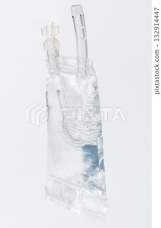 Transparent IV bag filled with sterile fluid against clean white background Transparent IV bag filled with sterile fluid against clean white background 132914447