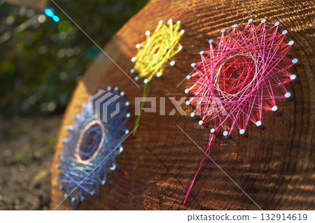 Thread art at the outer garden of Kinjasui Shrine: warmth of wood and colorful floral patterns 132914619