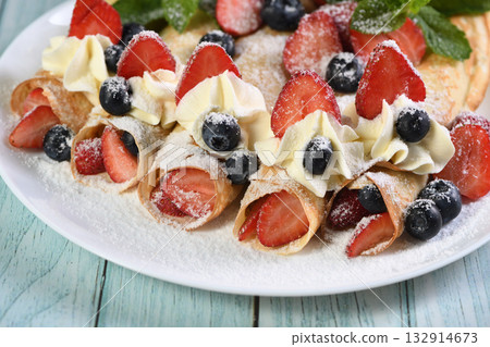 French crepes with cream and berries 132914673
