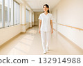 A positive female nurse walking down the corridor 132914988