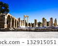 Exploring Ancient Ruins and Well-Preserved Columns Under a Clear Blue Sky in a Historic Archaeological Site 132915051