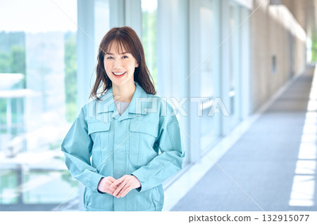 Portrait of a smiling female worker in work clothes 132915077