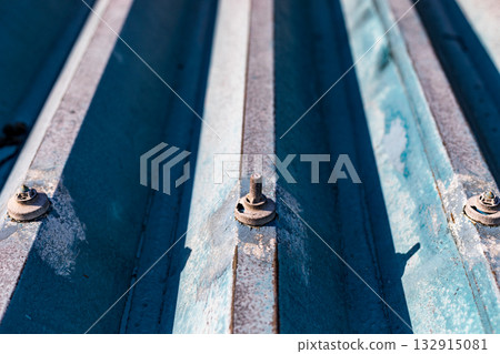 Repairing leaks from bolt caps on a warehouse's folded-plate roof 132915081
